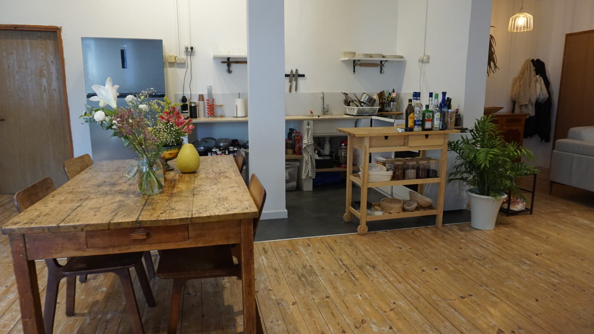 Kitchen and dining — wood table, open shelving, daylight