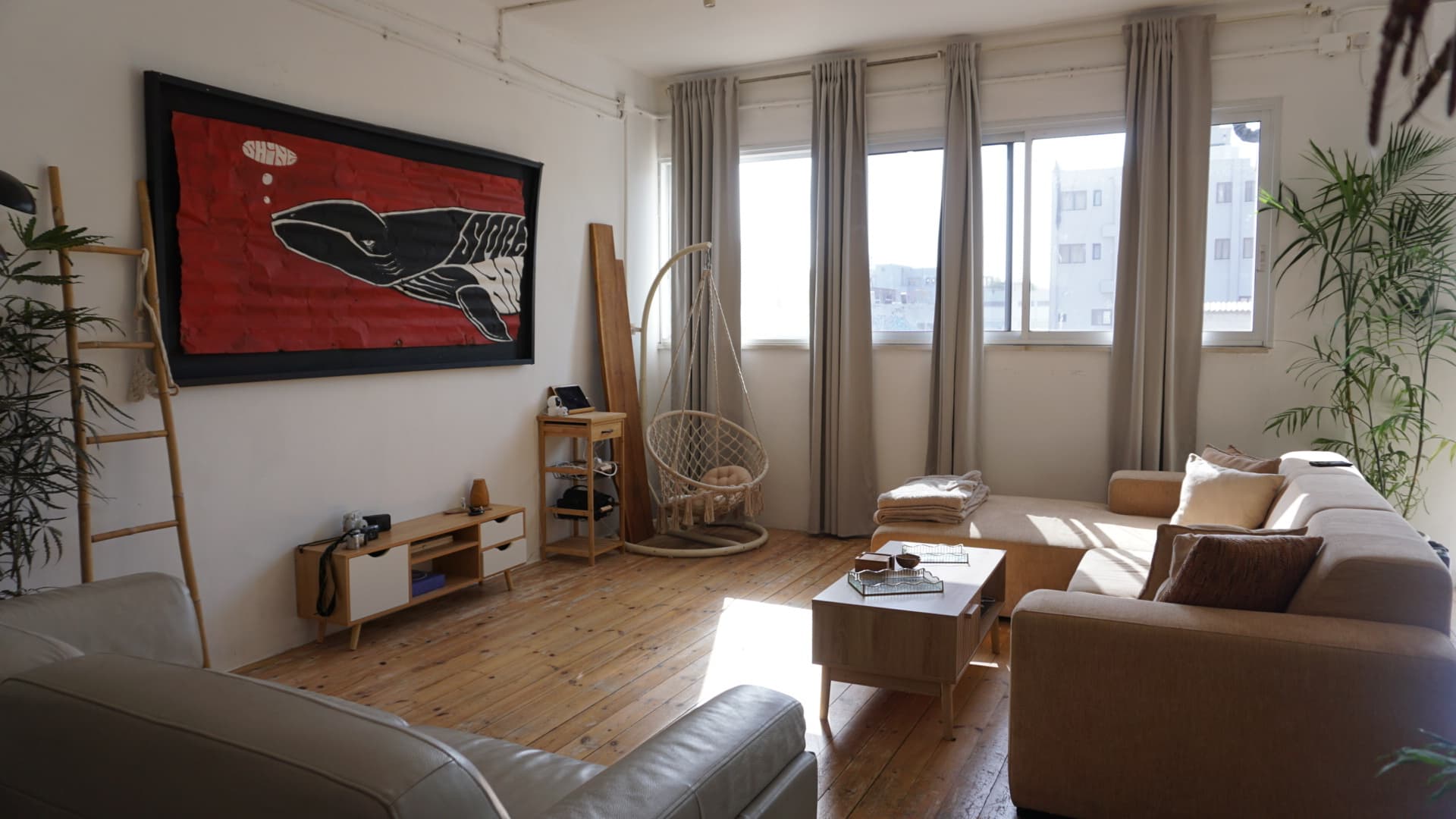 Living area — sectional, whale artwork, tall windows